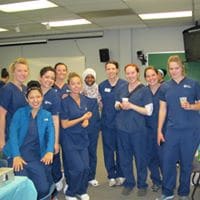 Dental hygienists smiling for a photo.