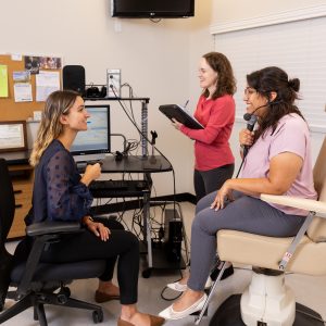 three women in a clinic practicing skills