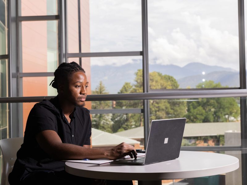 Zachariah Bess sitting at a computer in Health and Science building