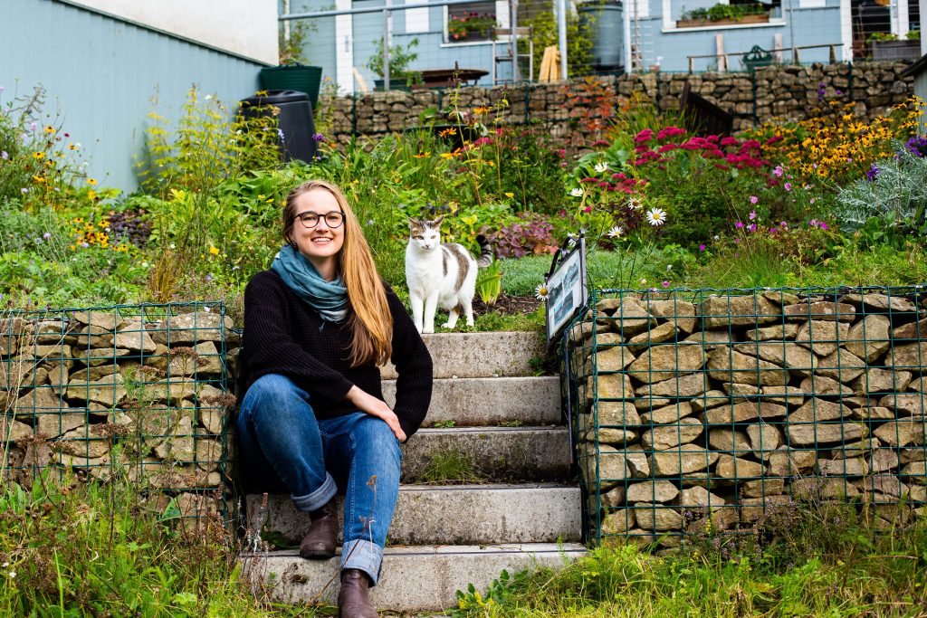 Susanna Dart at a flower garden with a cat