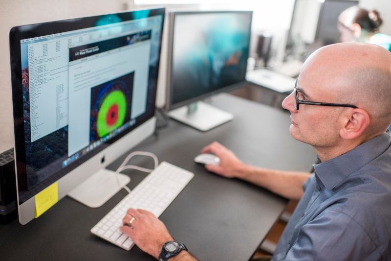 Astronomist looking on data on computer.