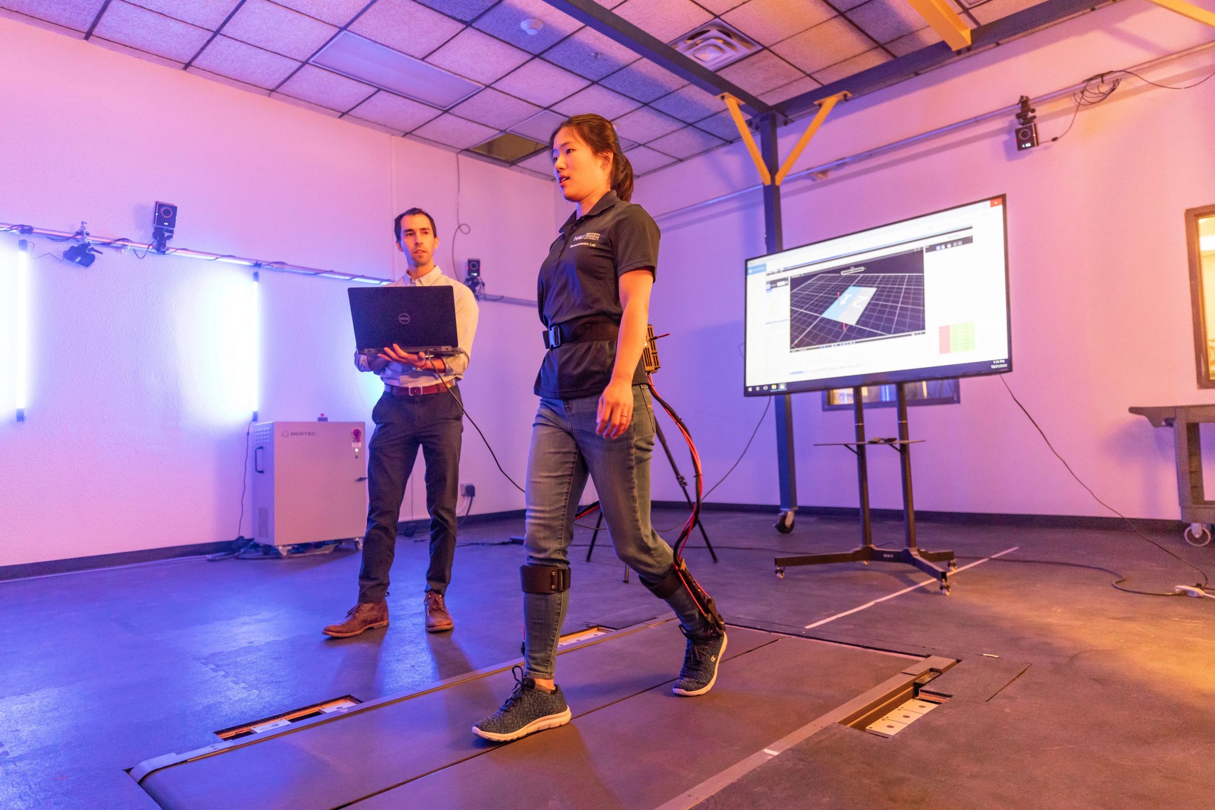 Assistant Professor Zach Lerner performing research in a high-tech laboratory.