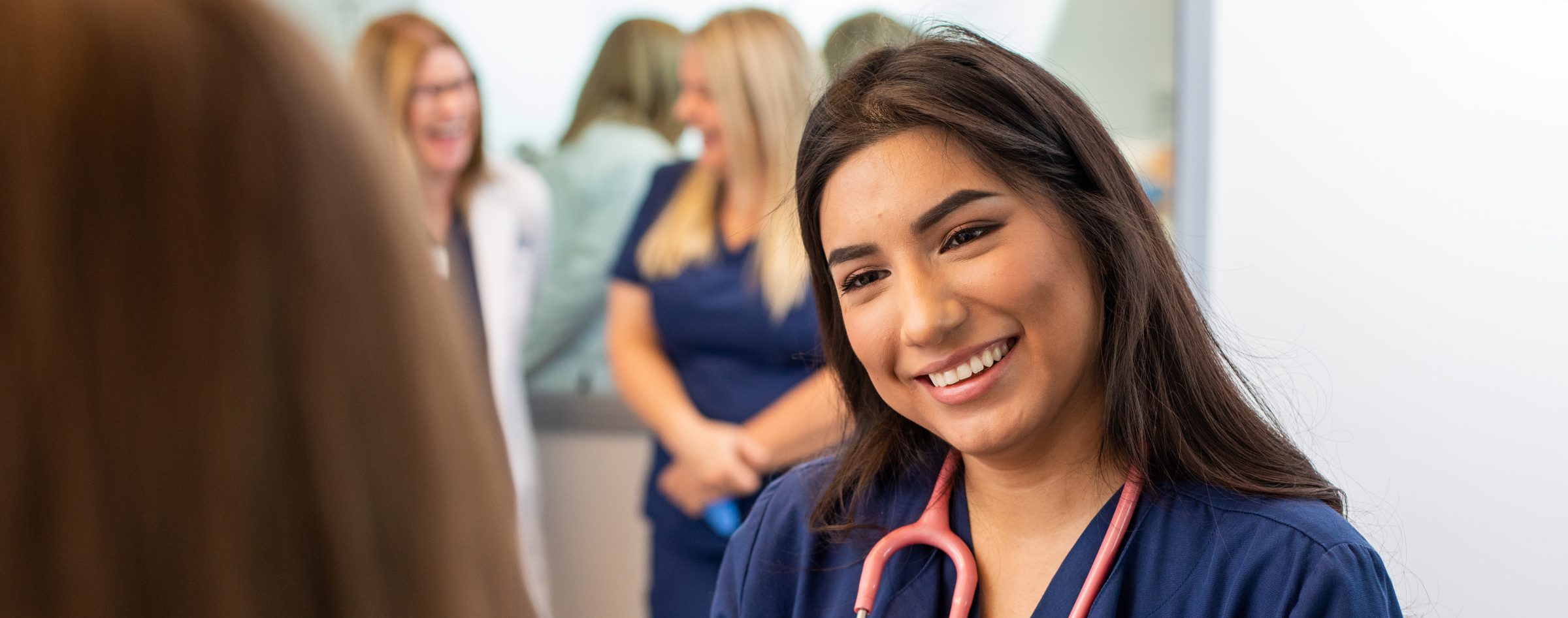 Female nursing student listening to someone talking.