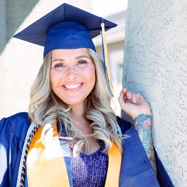 Raegan Liguori-Reid in NAU graduation cap and gown.