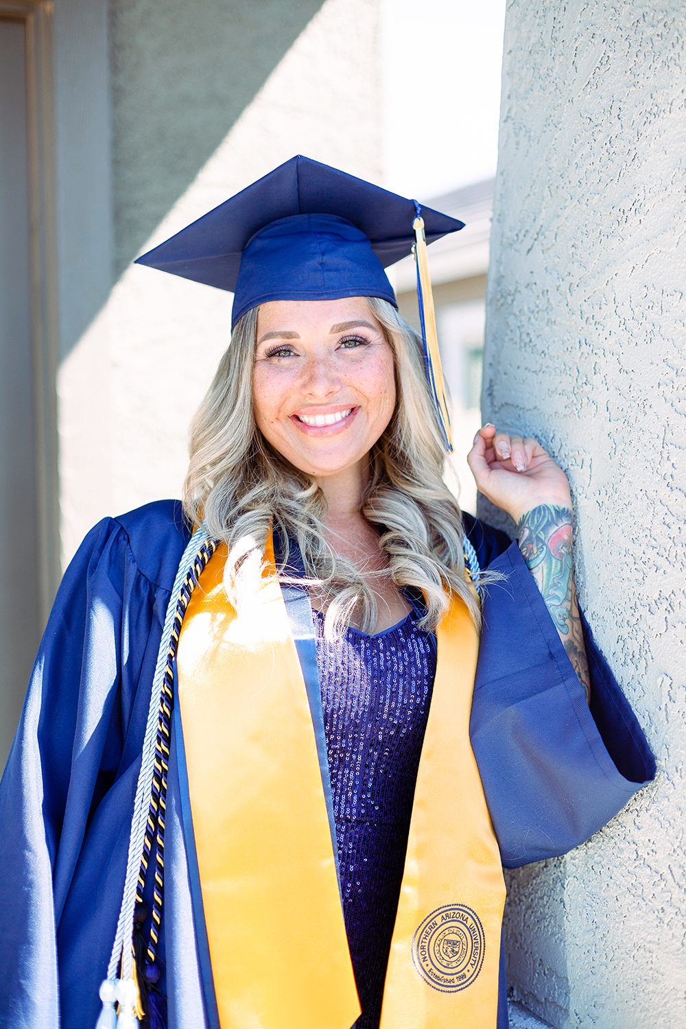 Raegan Liguori-Reid in NAU graduation cap and gown.