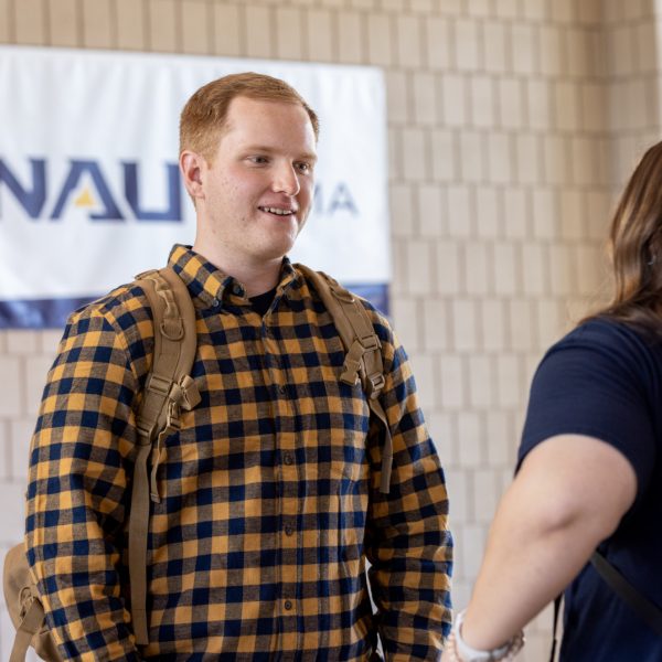 Jordan Allen talking with another NAU–Yuma student.
