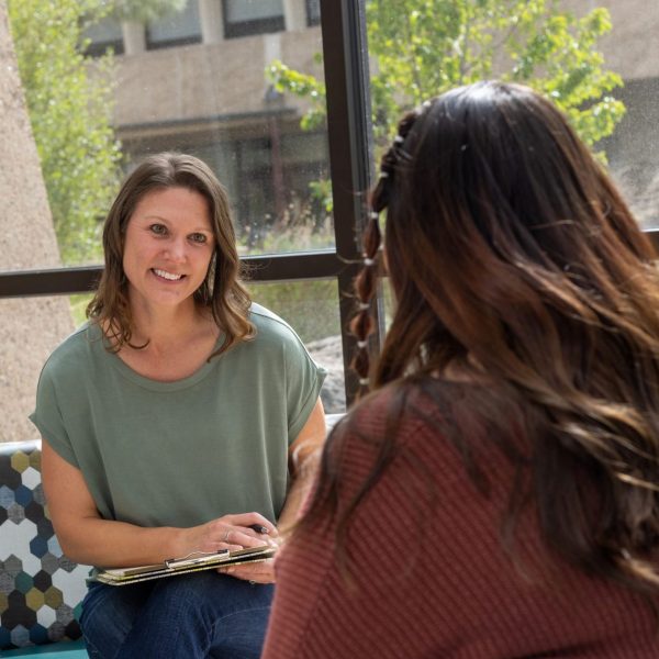 Katie Mommaerts talks with student.