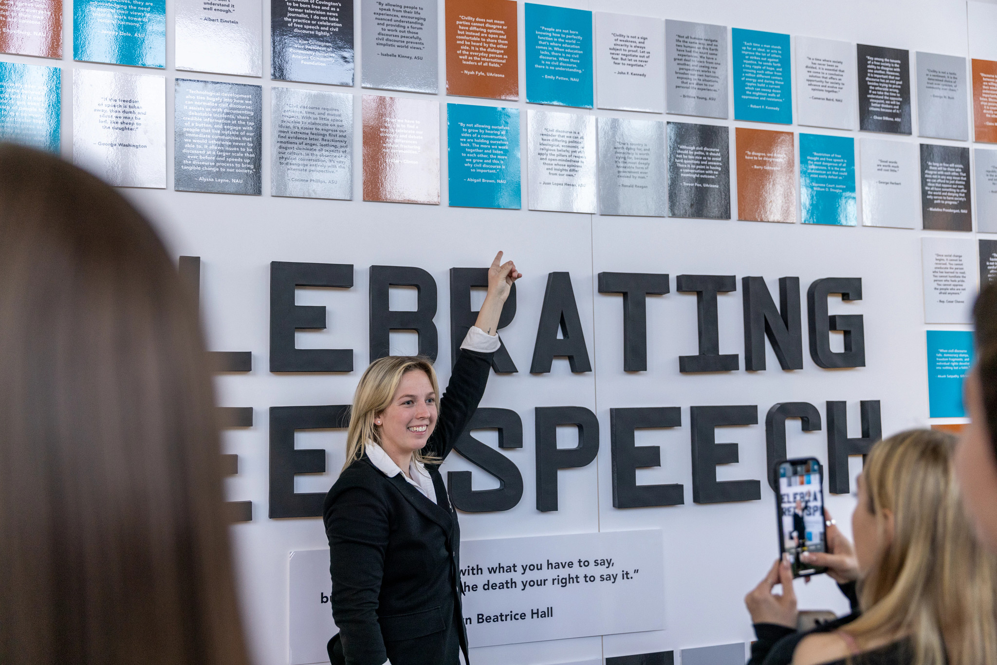 Abigail Brown standing in front of "Celebrating Free Speech" display board at Regents' Cup.
