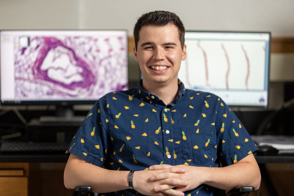 Lab manager Ron Allen sits in front of two computer screens in the Imaging and Histology Core Facility lab.