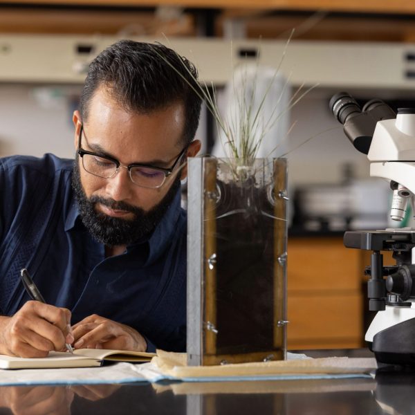 Center for Ecosystem Science and Society Associate Professor Javier Ceja-Navarro writing notes in his lab.