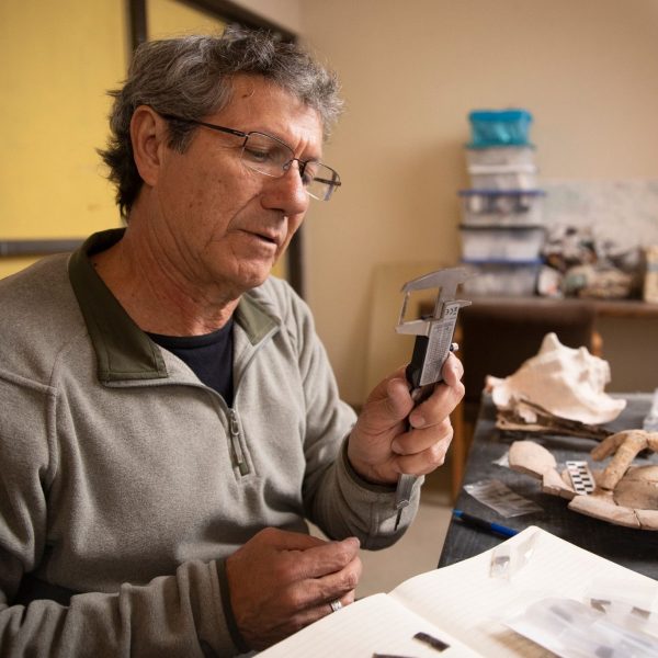 Professor Jaime Awe working with archaeological artifacts in his lab.