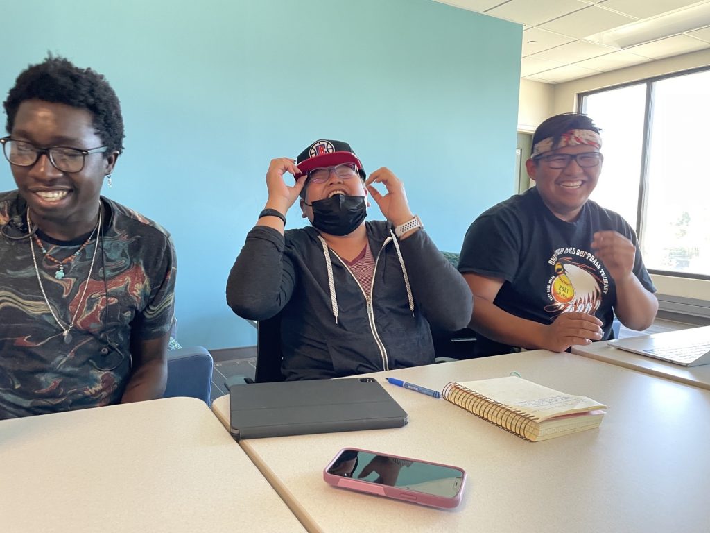 NAU students Melissa Howard and Denver Seaton and Diné College student Don Laurent relax after a long day.