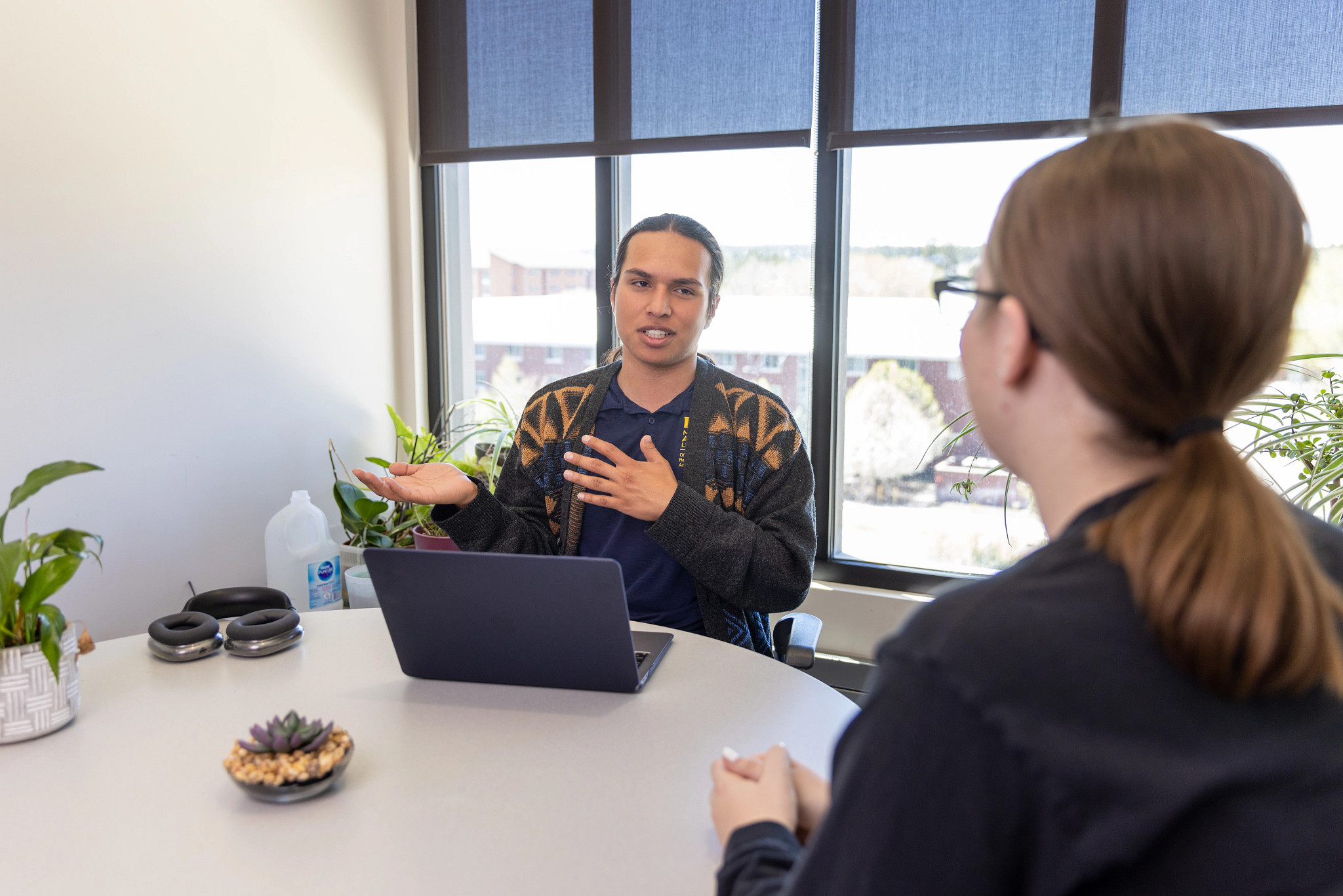 Undergraduate Research student Miguel Rosas talks with fellow student.