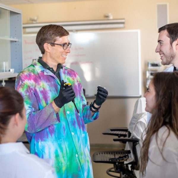 NAU–Yuma Clinical Professor of Biological and Natural Resource Sciences Francisco Villa talks with students in the genetics lab.