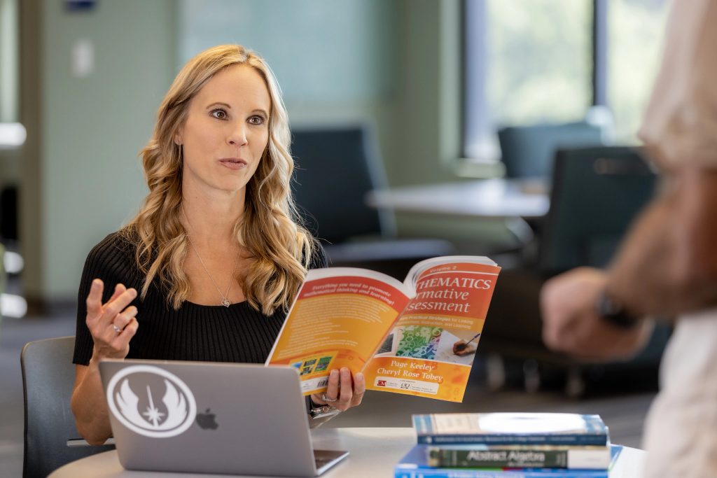 Mathematics Associate Professor Angie Hodge-Zickerman talks with a student.