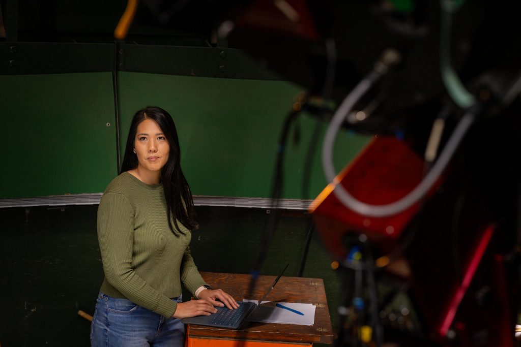 N A U P h D student in Astronomy and Planetary Science Ana Morgan works at a laptop computer inside campus observatory.