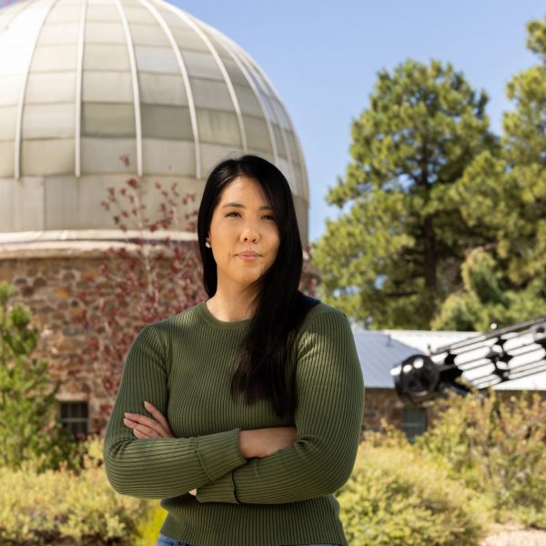 N A U P h D student in Astronomy and Planetary Science Ana Morgan stands outside campus observatory.
