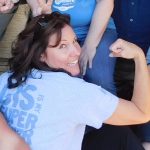 Lori flexes with a shirt that says, "GIS is my super power"