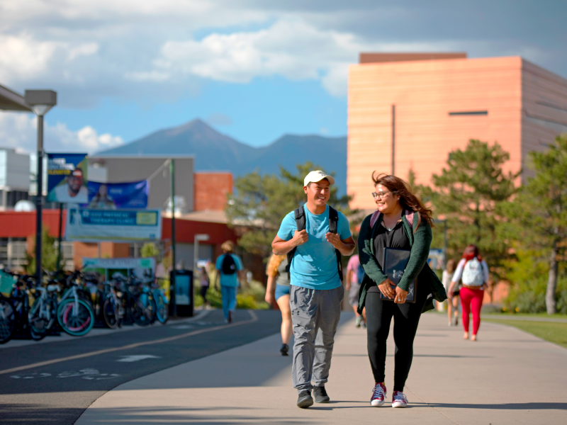 Two N A U students are walking on campus.