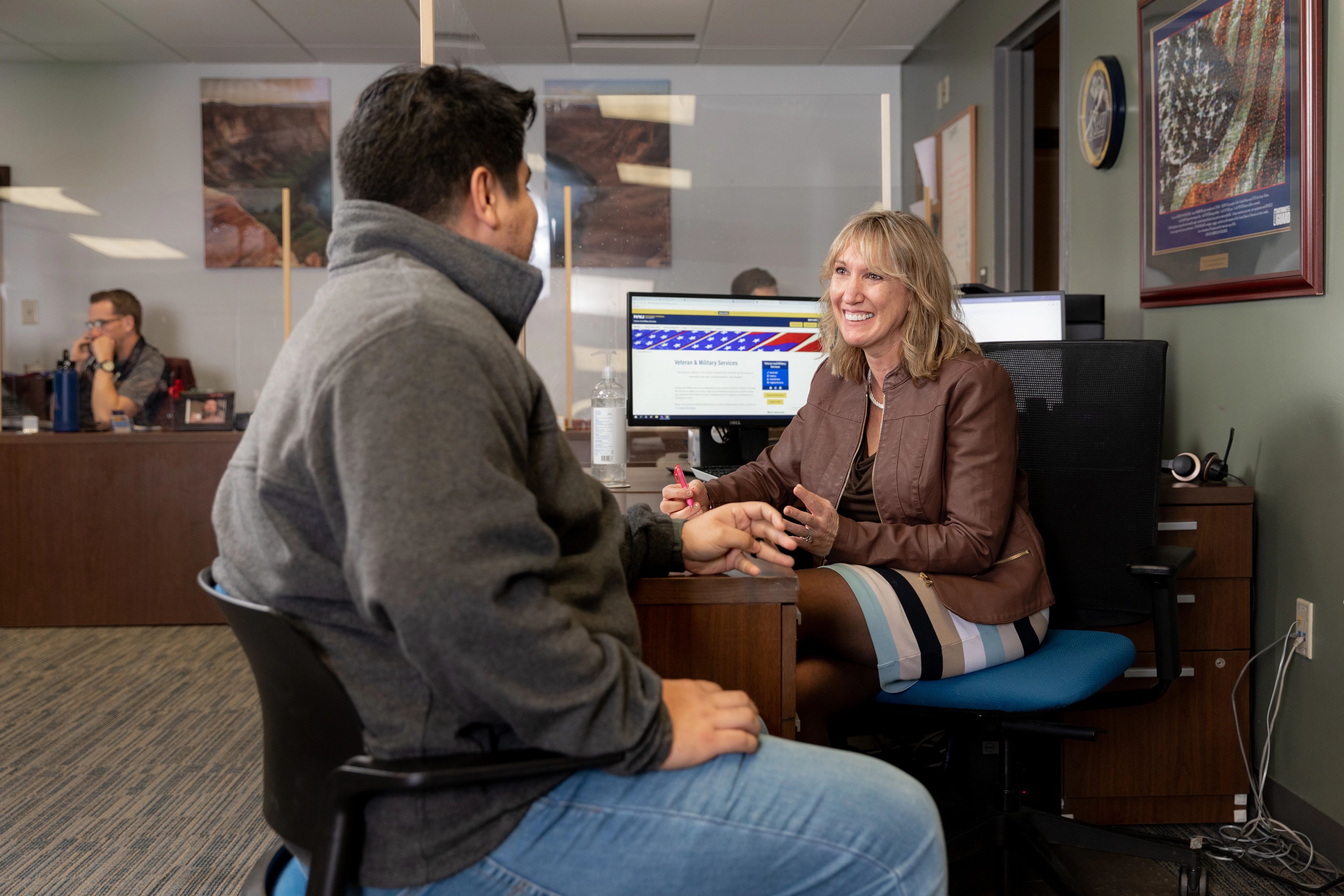 An N A U student meets with an advisor in the veteran success center.