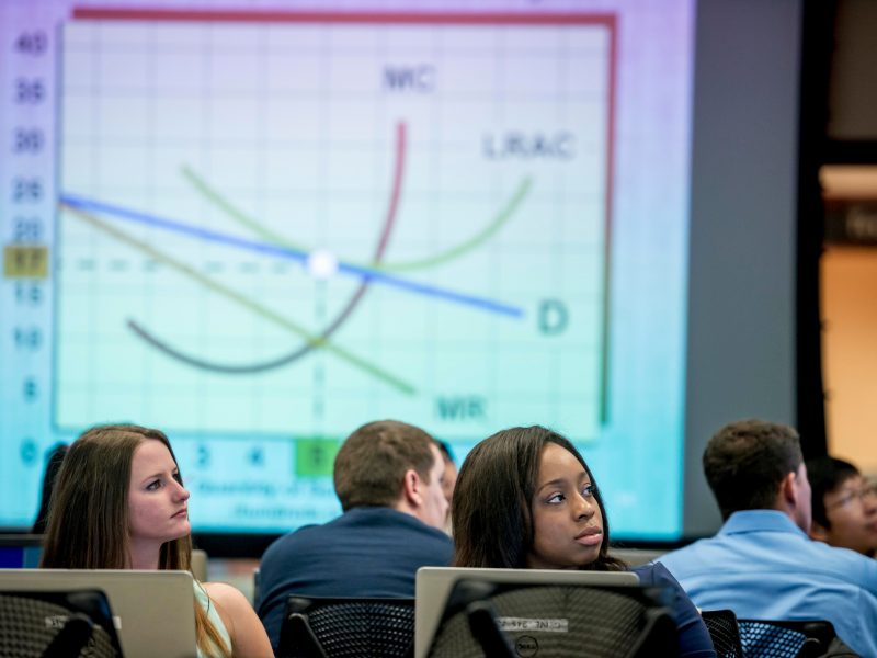 Students listening inside a business class in The W A Franke building.