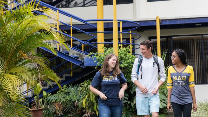 N A U students walking through a greenhouse.