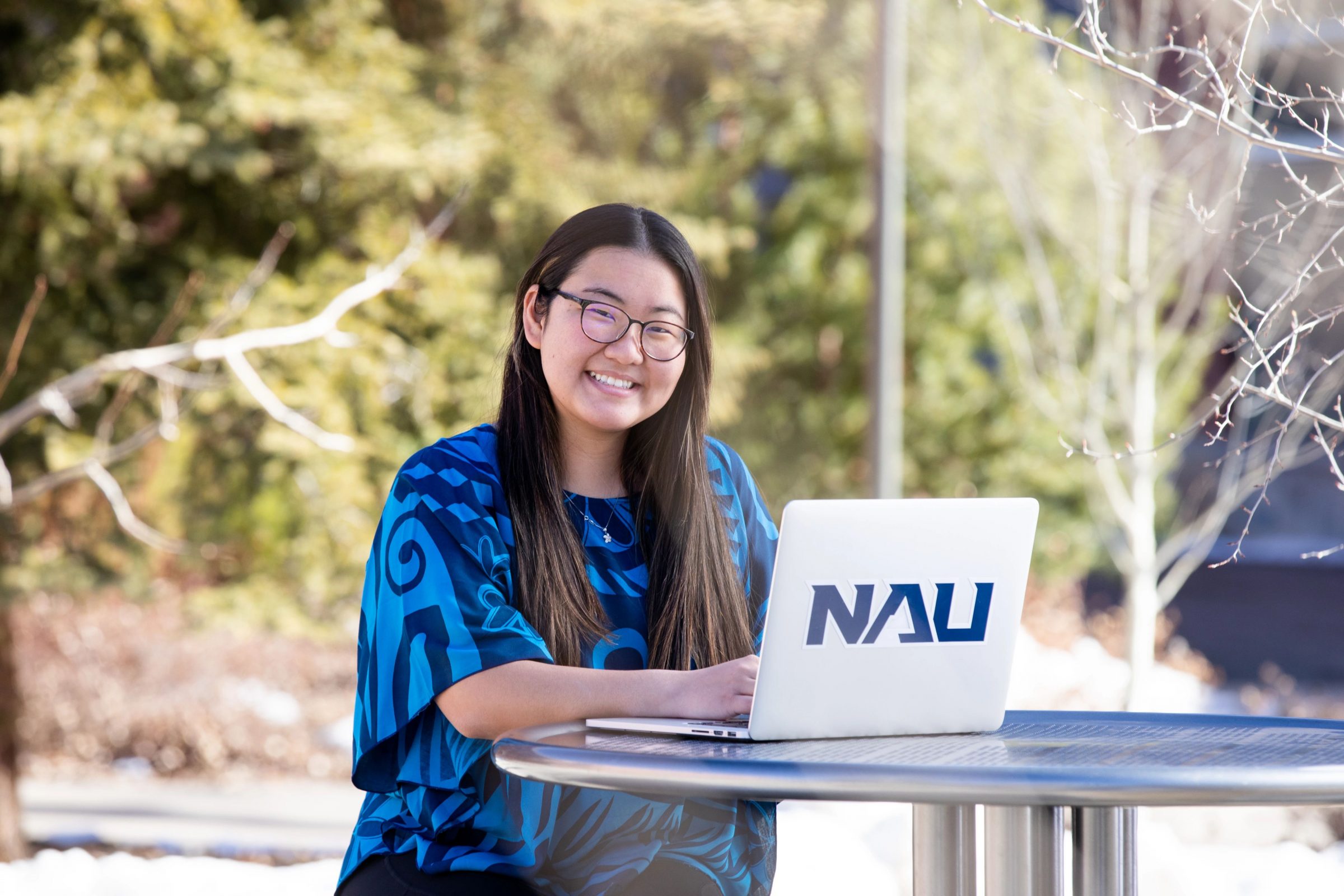 N A U student studying outside on campus.