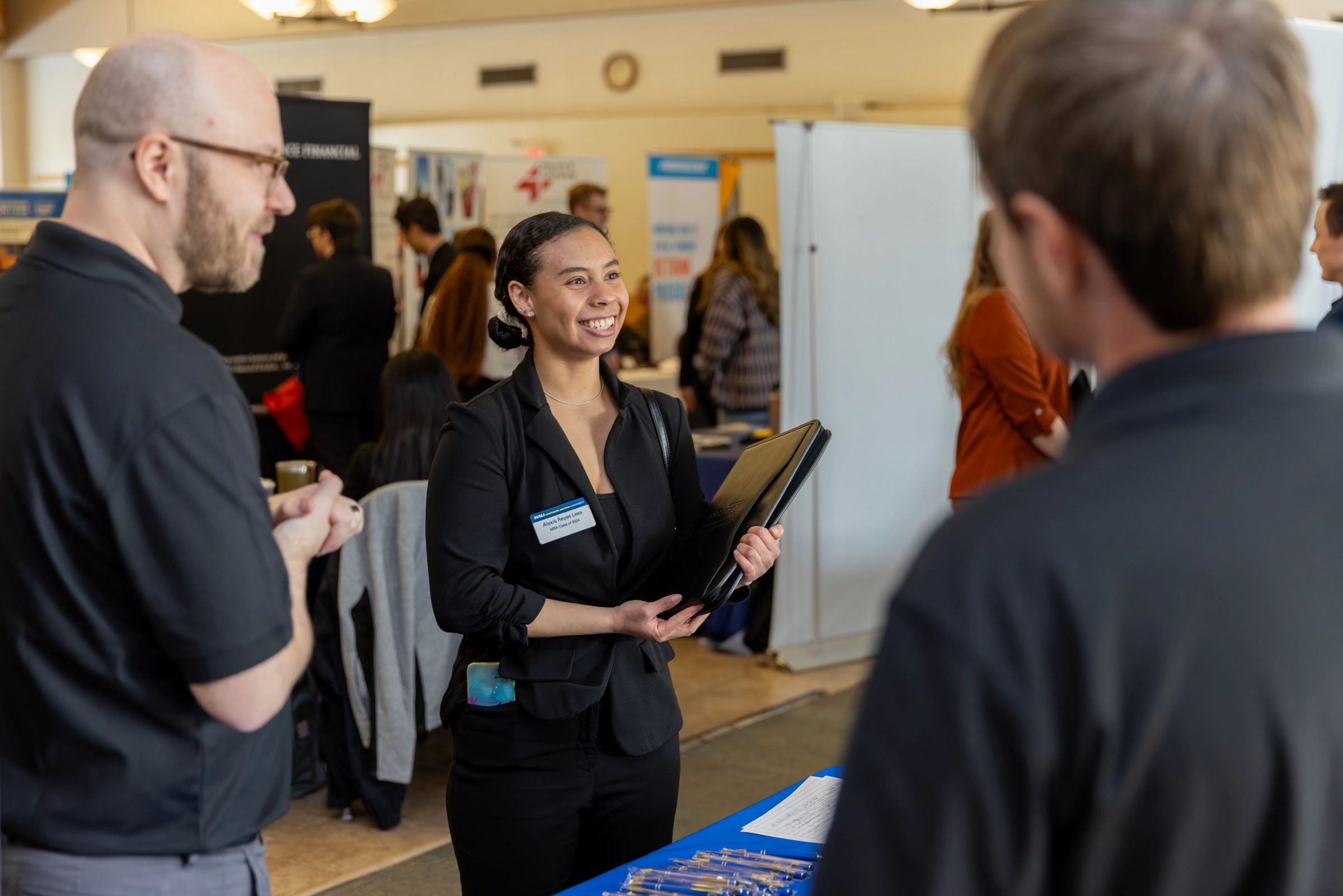 People talking to each other at the F C B career fair.