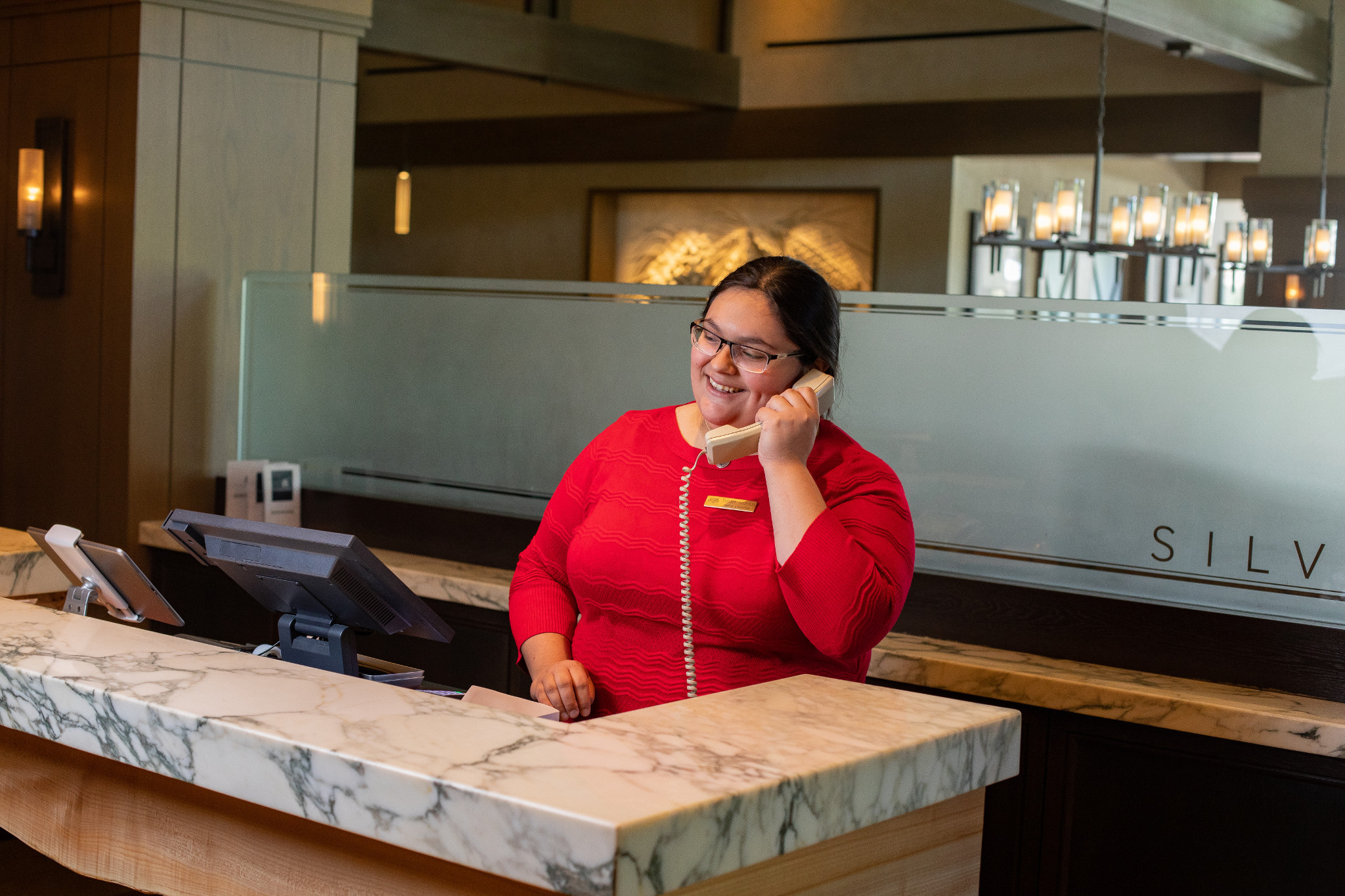 H R M student working the front desk and answering phone calls.