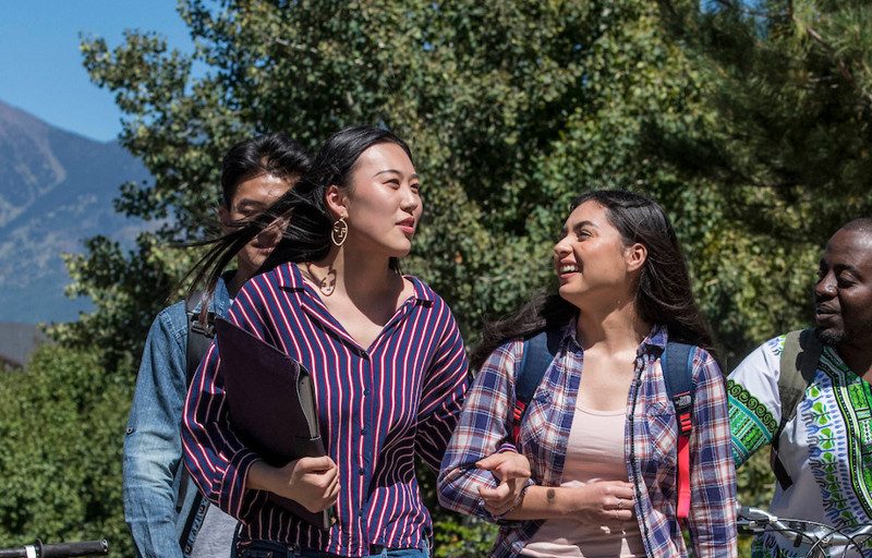 Students talking while walking outside.