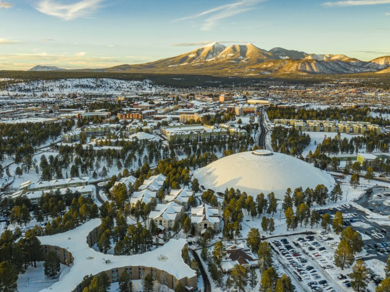 A drone shot of N A U covered in snow.