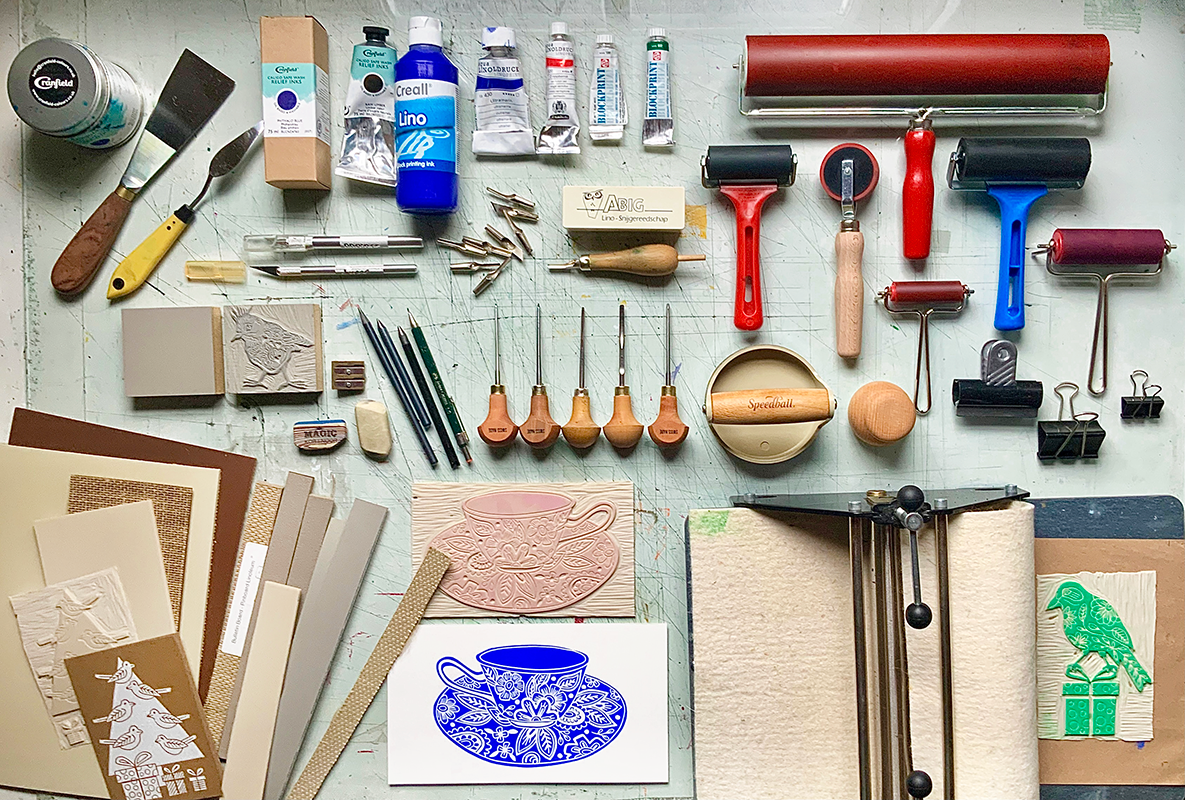 Painting and sculpting tools laid out and organized on a table.