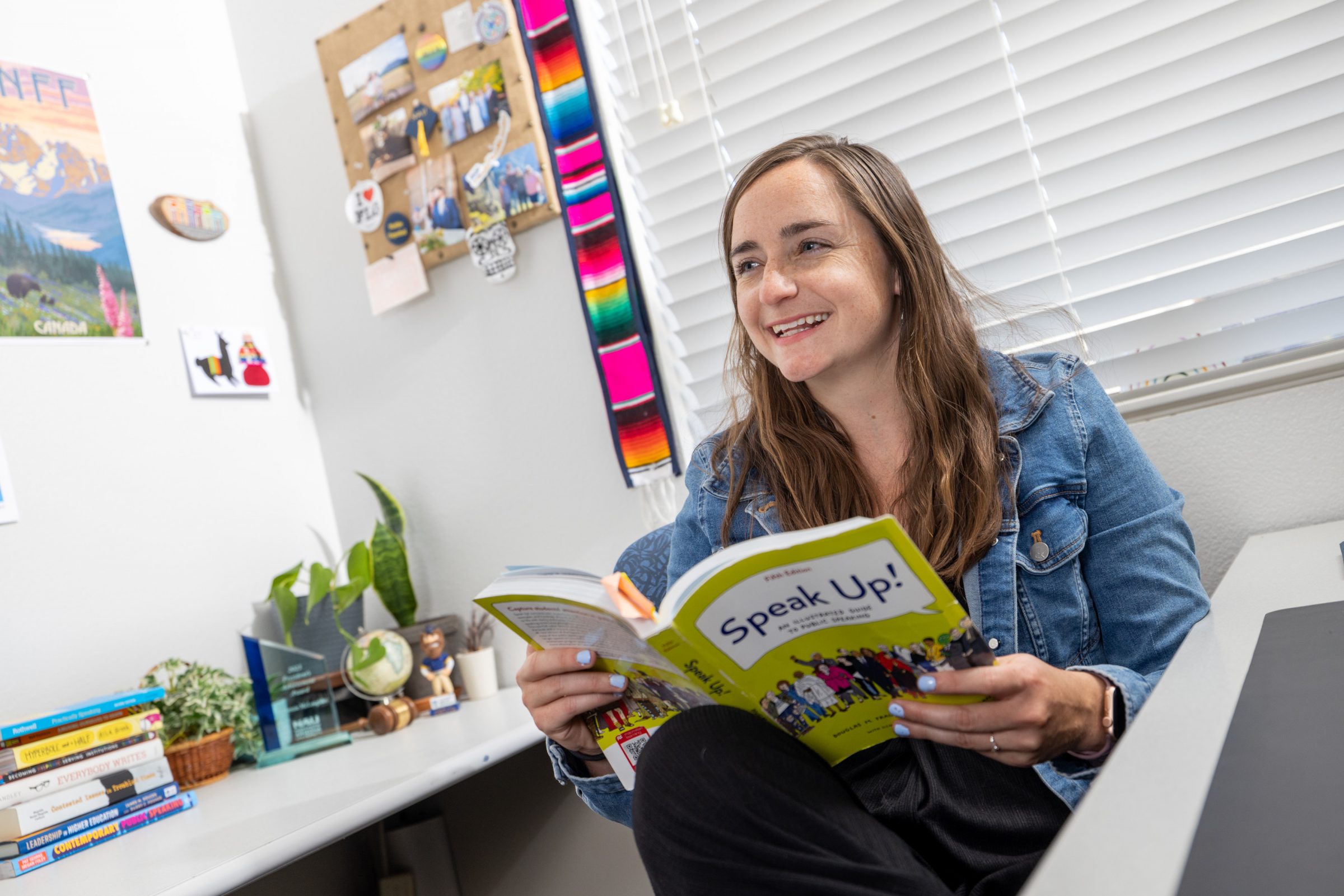 McKenzie McLoughlin reads a book called "Speak Up!" in their office.