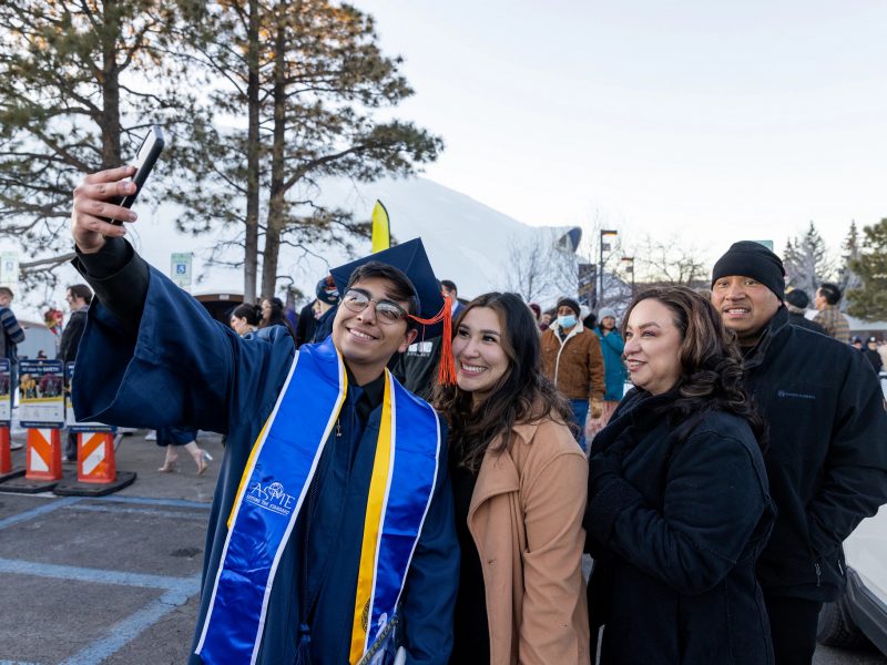 New grad taking a photo with family.