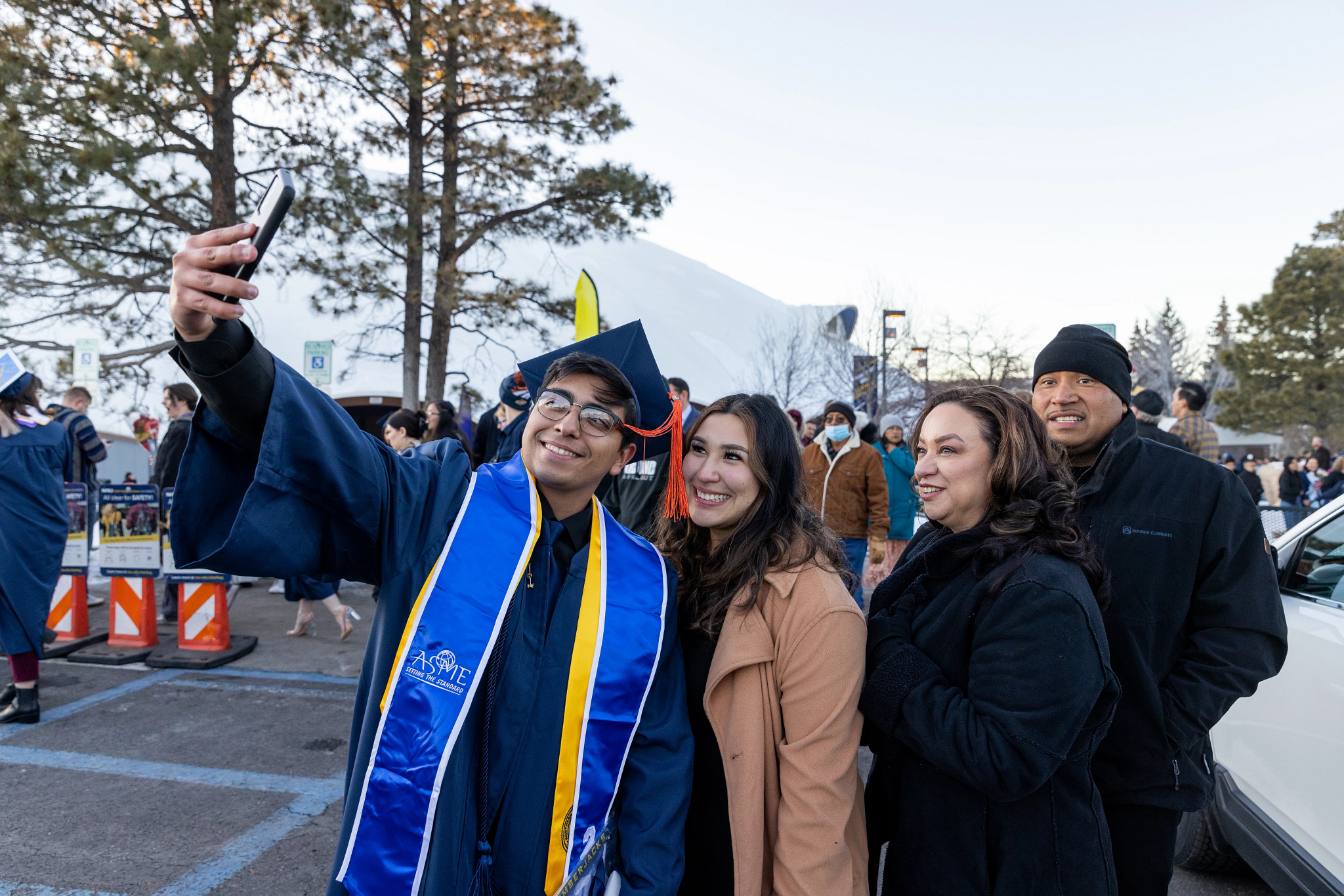 New grad taking a photo with family.