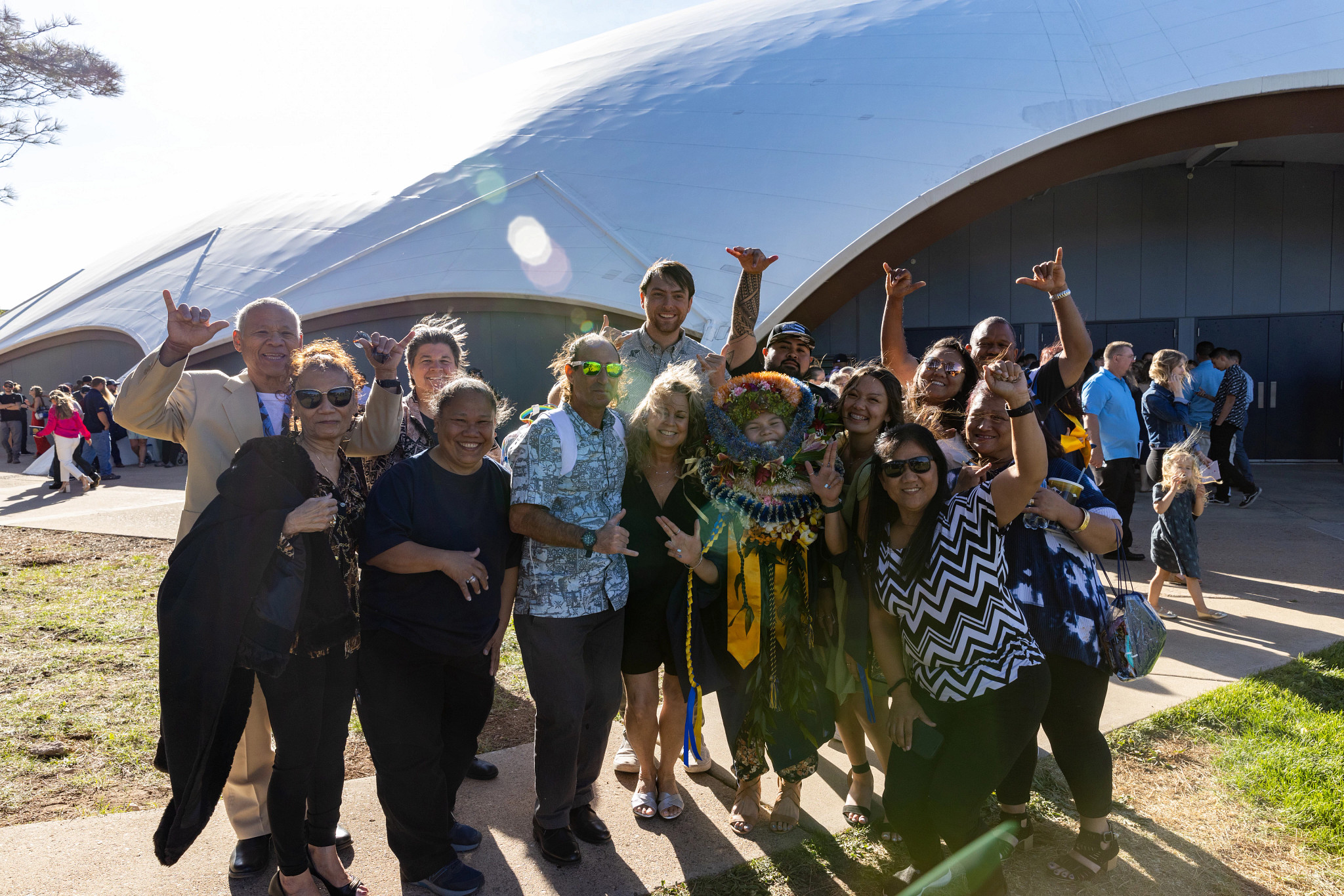 NAU graduate celebrating with family standing outside the Skydome