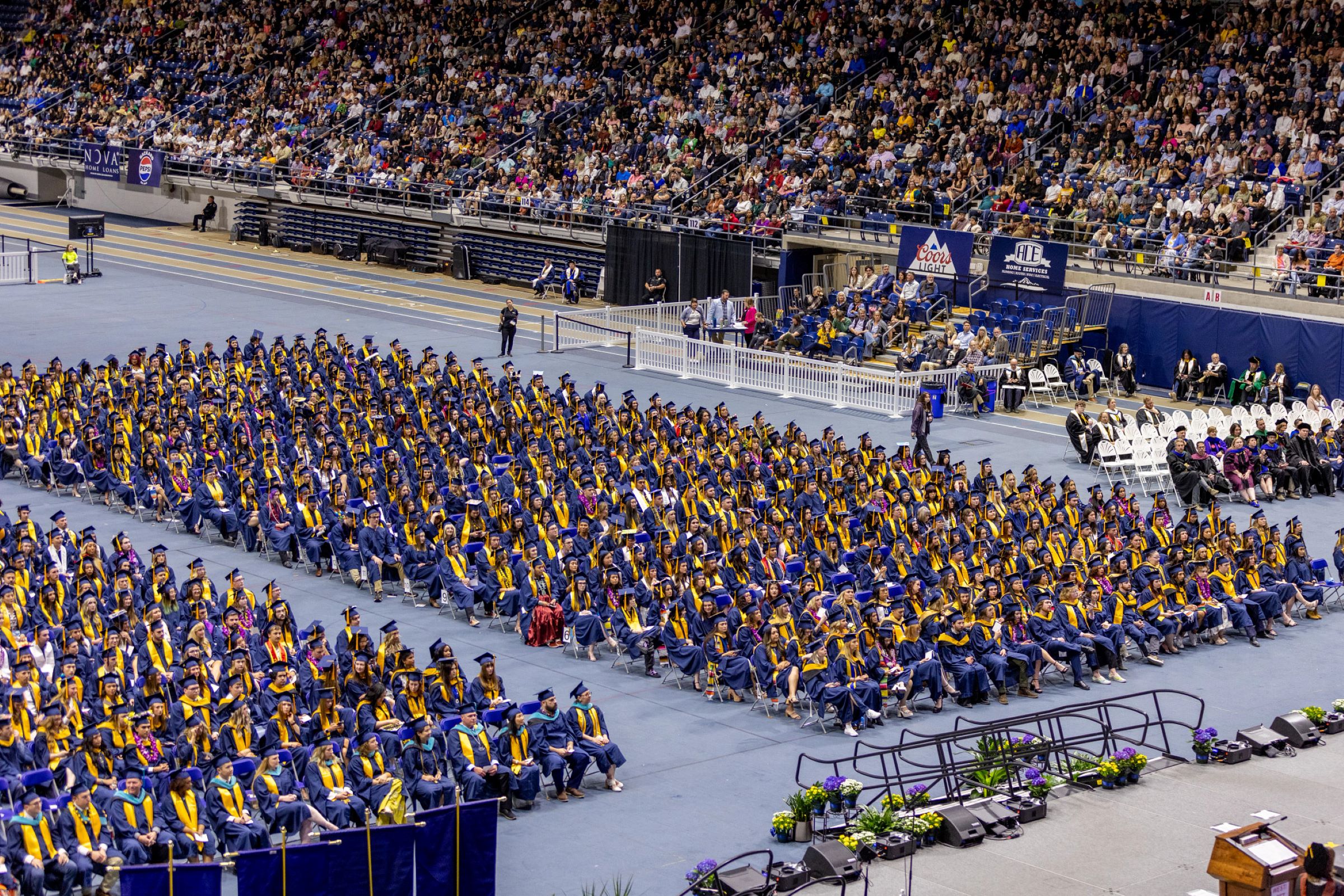 An aerial photo of students sitting at N A U commencement.