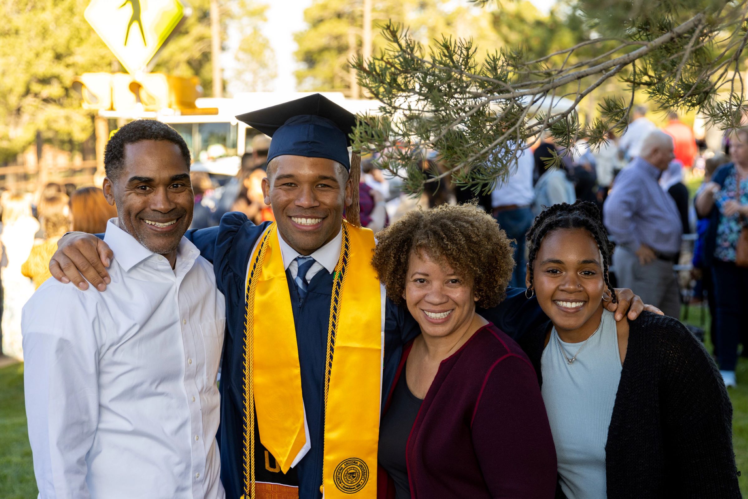 A photo of a student and family members at N A U commencement.