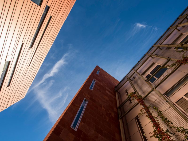 Looking up towards the sky between two buildings on Flagstaff campus.