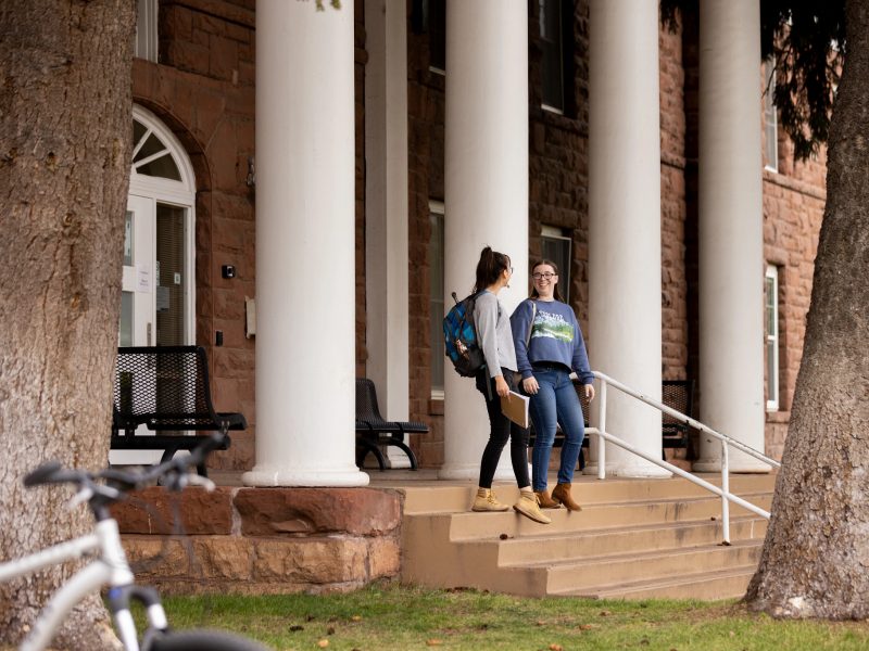 Students walking out of a campus building.