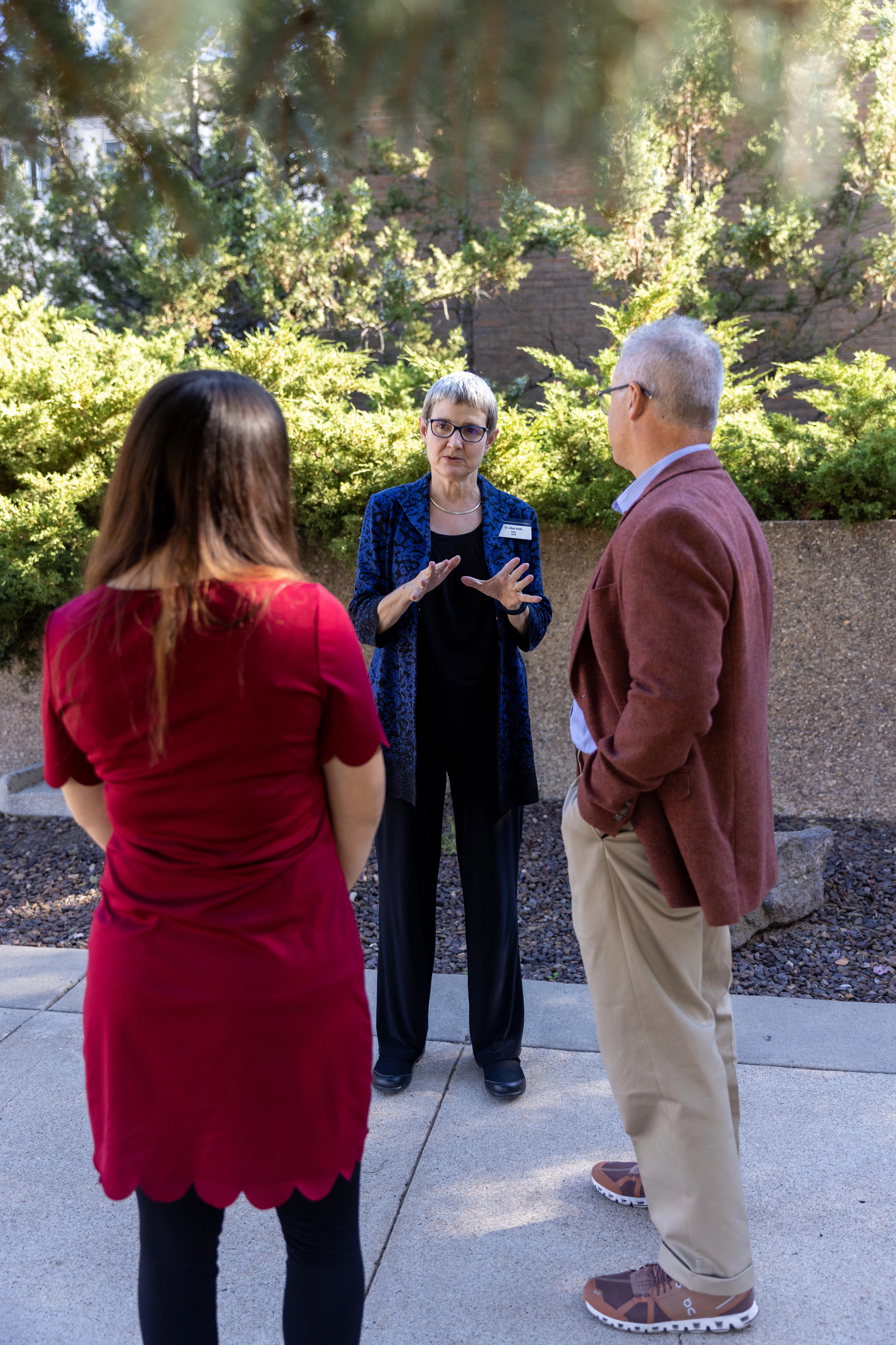 C H H S staff leading a tour through N A U's mountain campus.