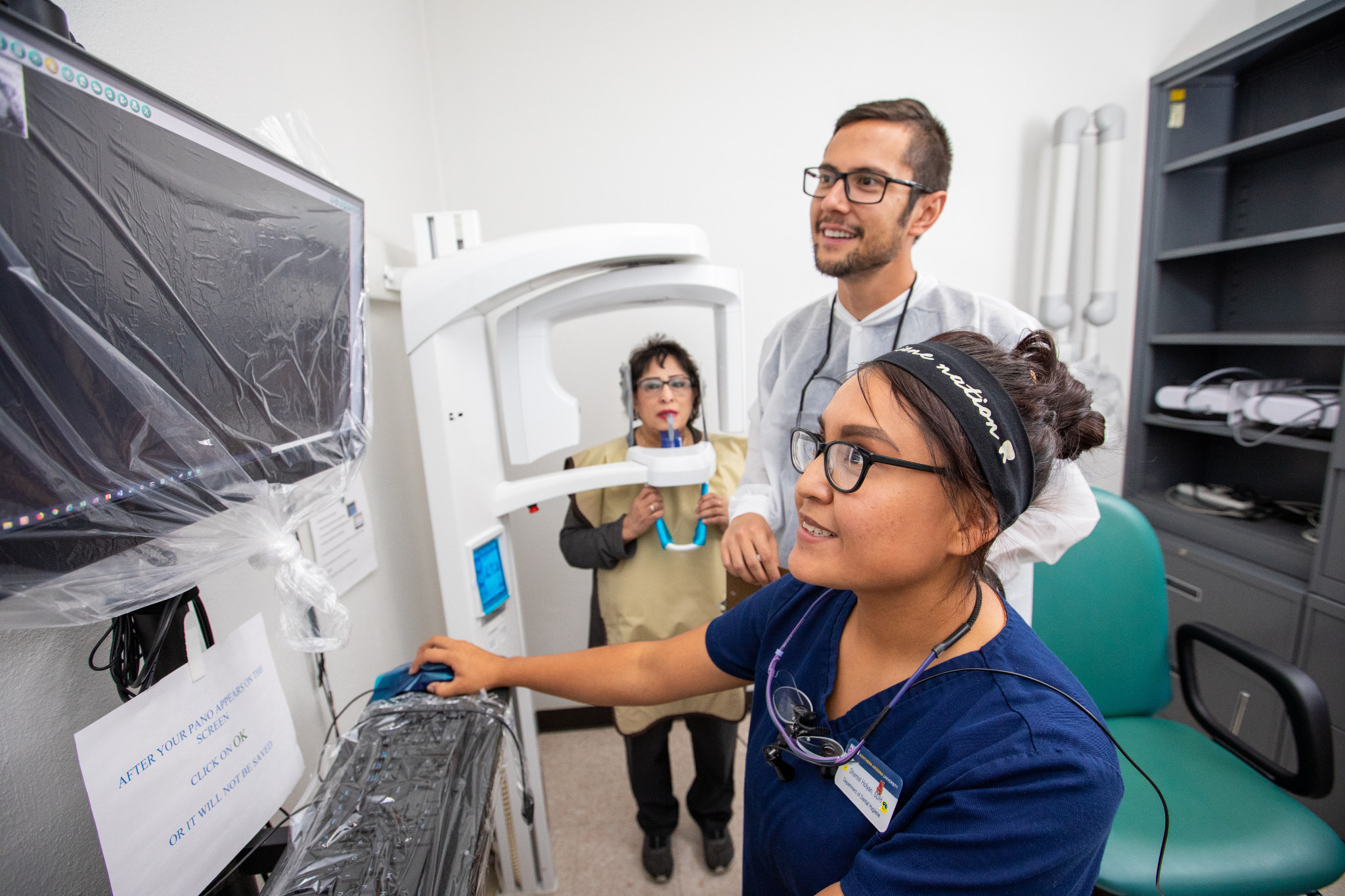 Dental Hygiene students examining x-ray.