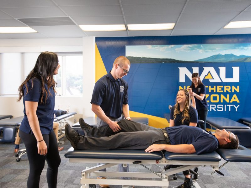 Physical therapy students working on a patient.