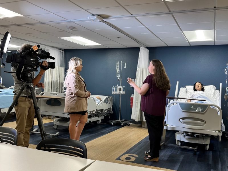 A news anchor interviews a N A U nursing teacher.