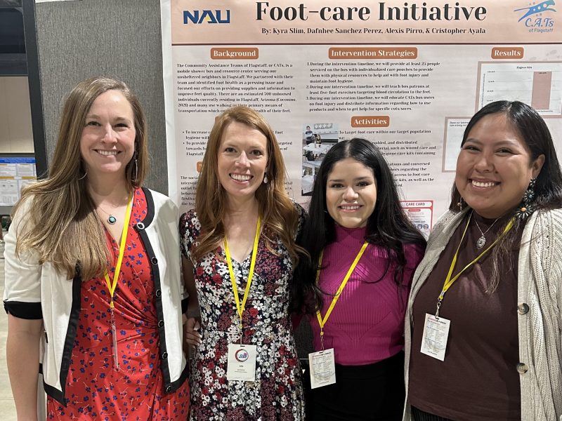 A group of people smiling at an event.