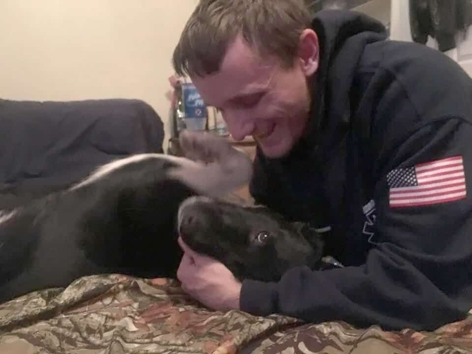 Kenneth Silverwind playing with his dog.