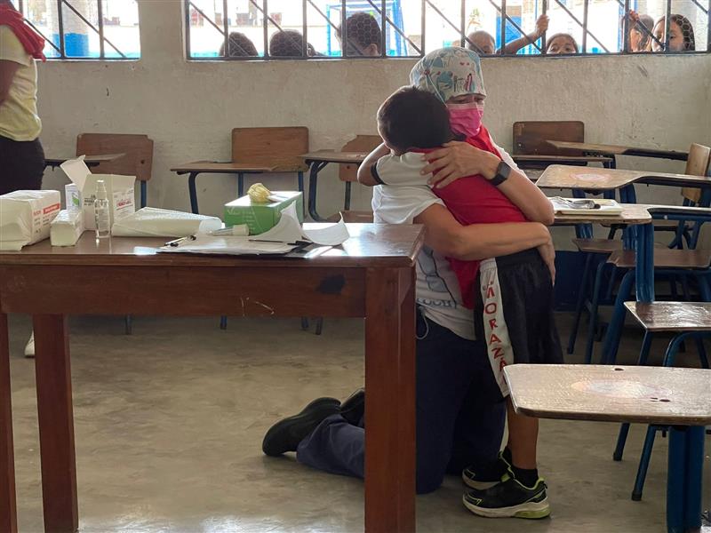 Dental hygienist, Jenny Zamora-Garcia, hugging a patient in Guatemala.