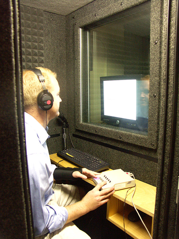 Benjamin Tucker recording conversations in a sound lab.