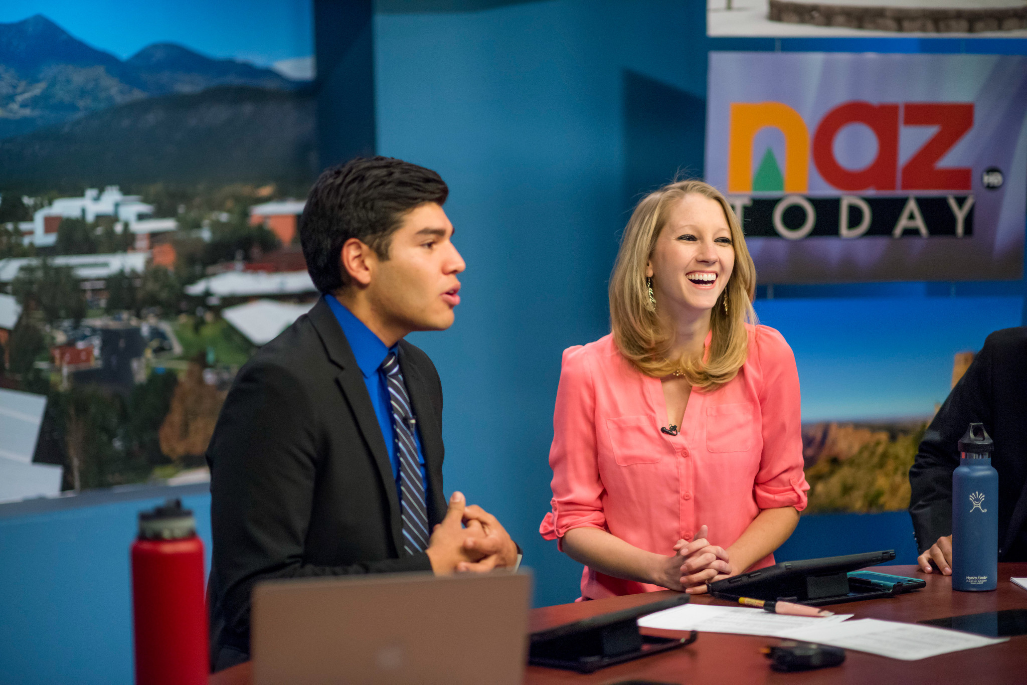 N A U N A Z reporters are talking to the camera on set.