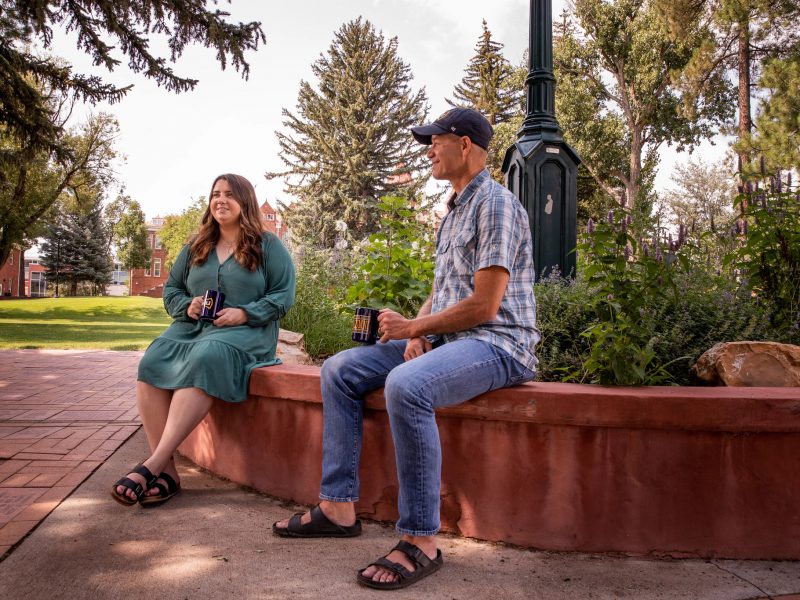 Alumni sitting outside.